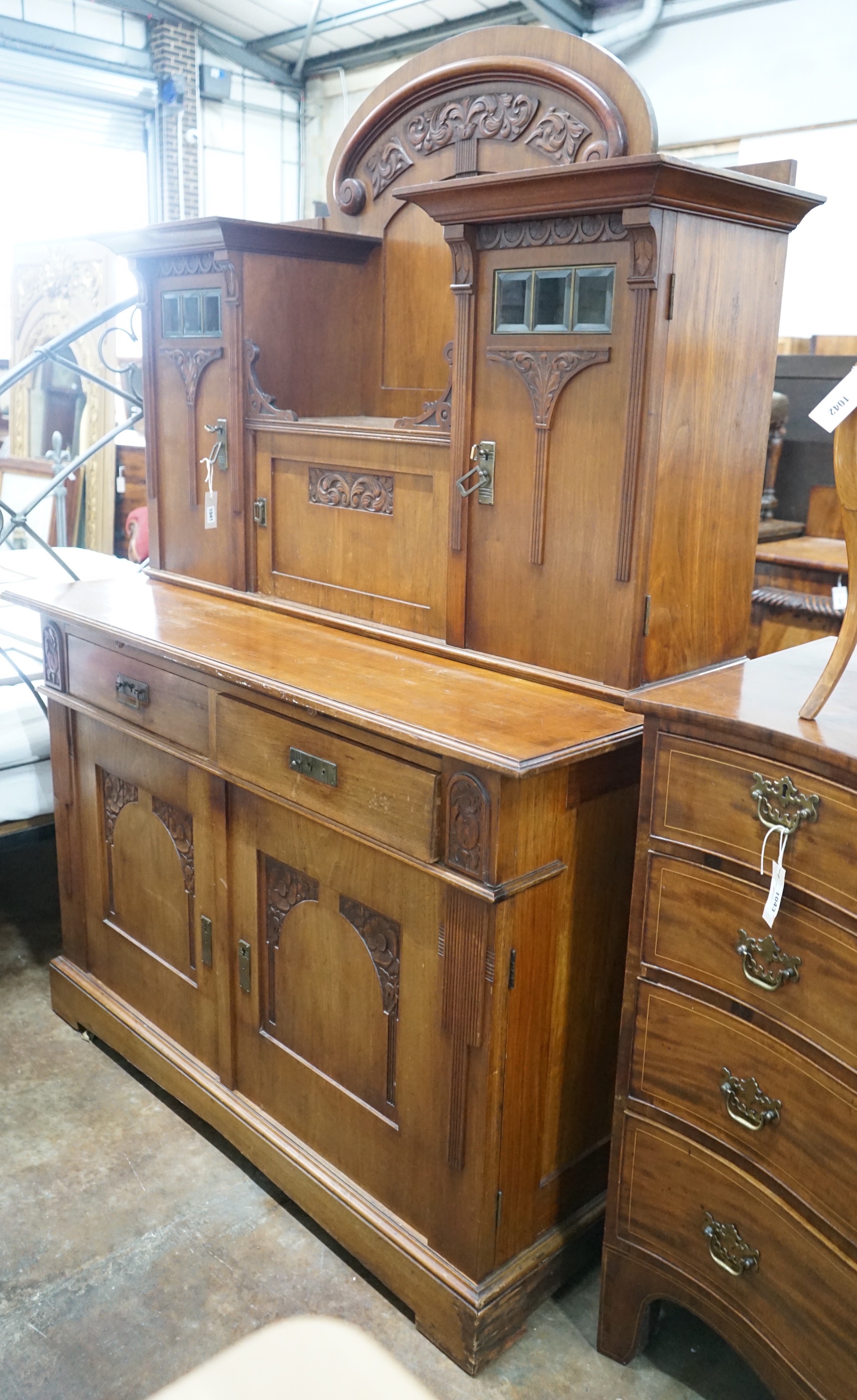 An early 20th century German Art Nouveau walnut buffet, length 141cm, depth 64cm, height 197cm